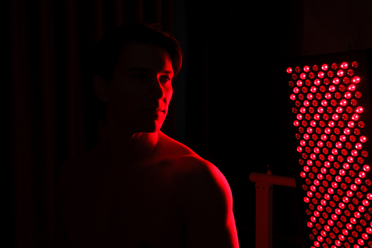 barbat utilizand panou cu lumina rosie pentru fotobiomodulare